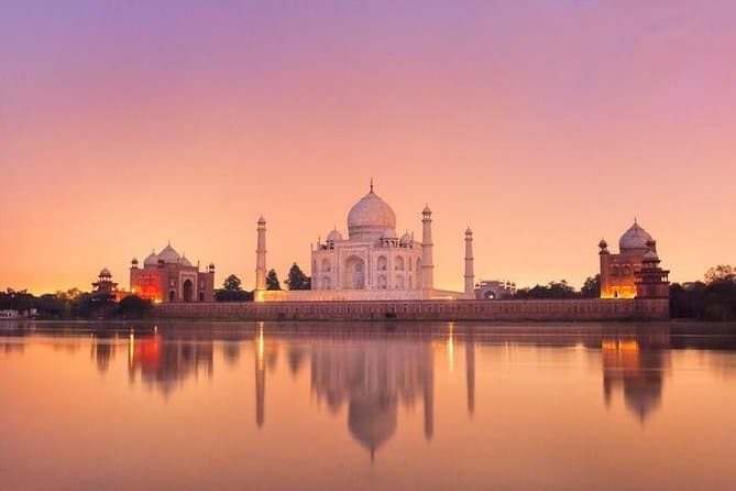 Taj Mahal reflected in still water at sunset
