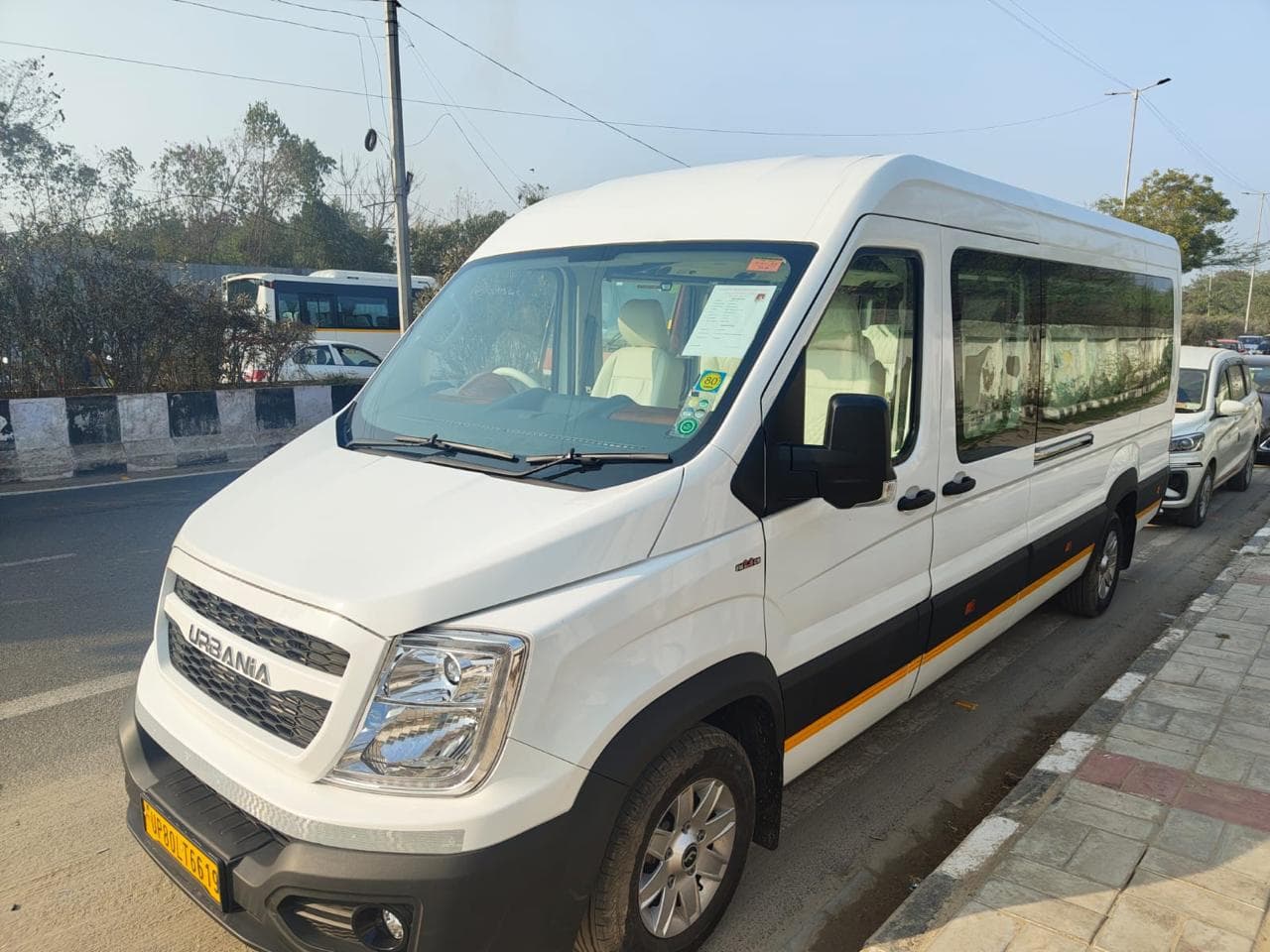 White Urbania tempo traveller parked roadside