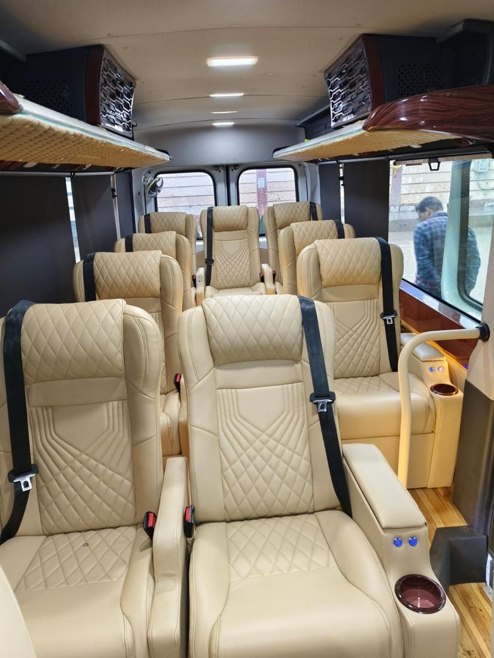 Wide view of the tan leather cabin with wood-panelled ceiling