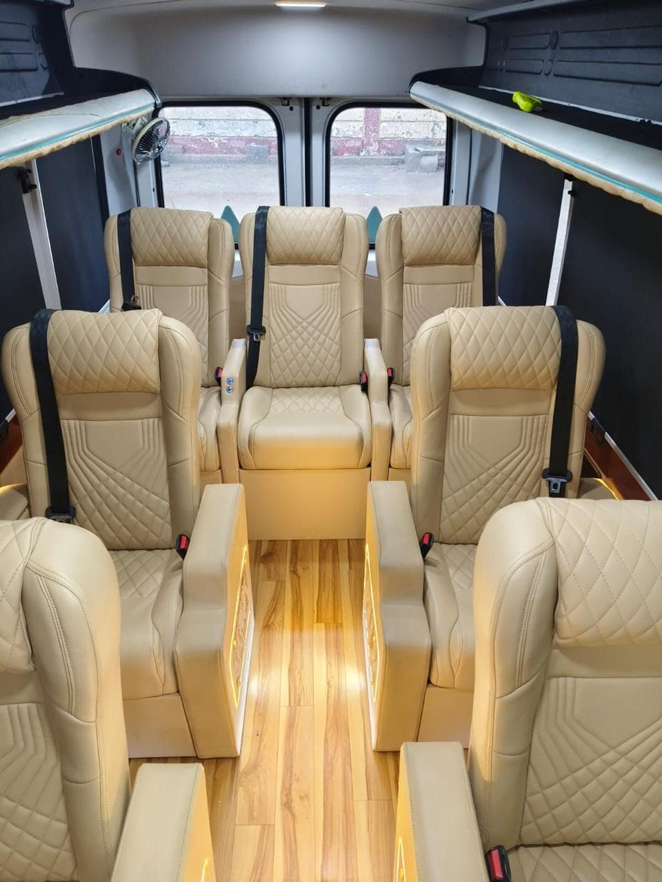 Reclining captain seats with mood lighting inside the tempo traveller